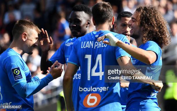 Marseille's French midfielder Matteo Guendouzi celebrates with Marseille's French midfielder Valentin Rongier after scoring a goal during the French...