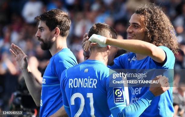 Marseille's French midfielder Matteo Guendouzi celebrates with Marseille's French midfielder Valentin Rongier after scoring a goal during the French...