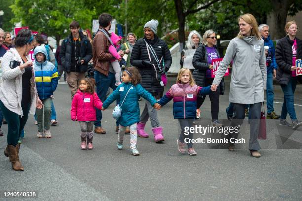 Abortion-rights activists walk to a Mothers Day demonstration outside the U.S. Supreme Court on May 8, 2022 in Washington, DC. The building,...
