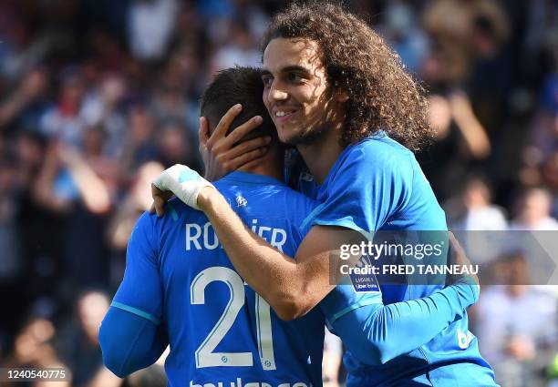 Marseille's French midfielder Matteo Guendouzi celebrates with Marseille's French midfielder Valentin Rongier after scoring a goal during the French...