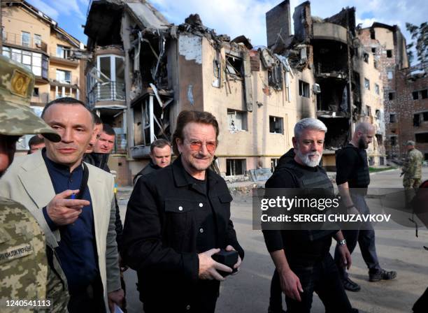 Bono , activist and front man of the Irish rock band U2 inspects the damage to a residential area in the Ukrainian town of Irpin, near Kyiv on May 8,...
