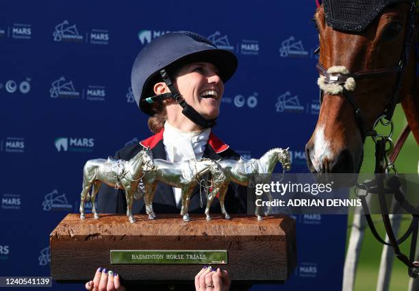 Britain's Laura Collett smiles beside her horse, as she holds the new Badminton Horse Trials trophy after her win with London 52, at the presentation...