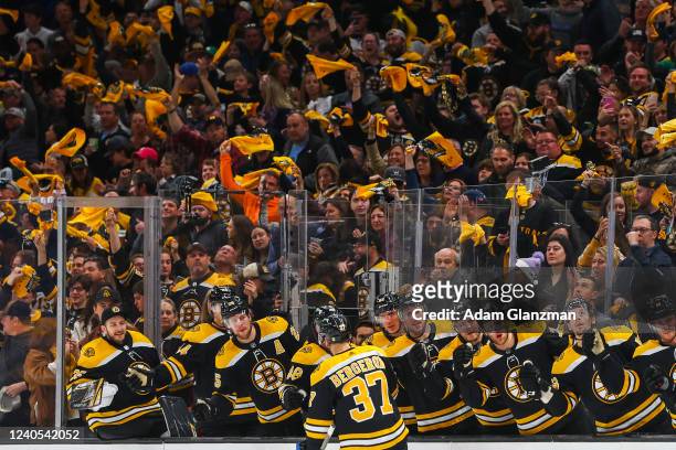 Patrice Bergeron of the Boston Bruins high fives his teammates after scoring in the first period against the Carolina Hurricanes in Game Four of the...
