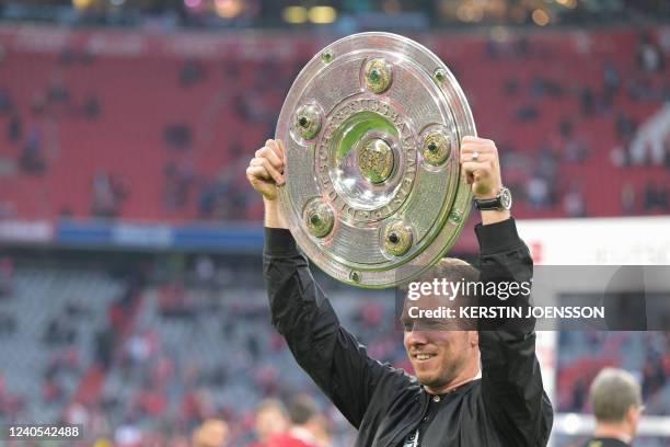 Bayern Munich's German head coach Julian Nagelsmann celebrates with the trophy after the German first division Bundesliga football match between FC...