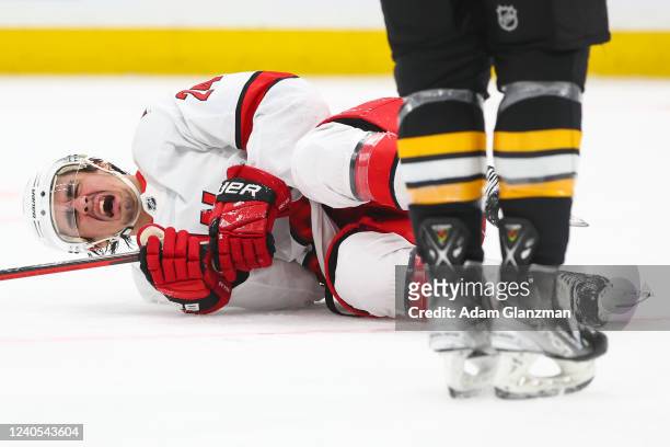 Seth Jarvis of the Carolina Hurricanes reacts after being hit by a loose puck in the second period against the Boston Bruins in Game Four of the...