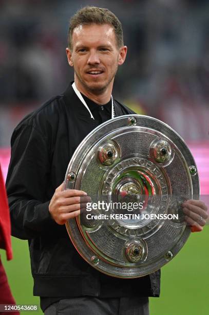 Bayern Munich's German head coach Julian Nagelsmann celebrates with the trophy after the German first division Bundesliga football match between FC...