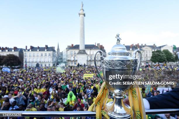 The French Cup trophy is presented aboard an open-top bus to FC Nantes supporters on Marechal Foch Square in Nantes, western France on May 8 a day...