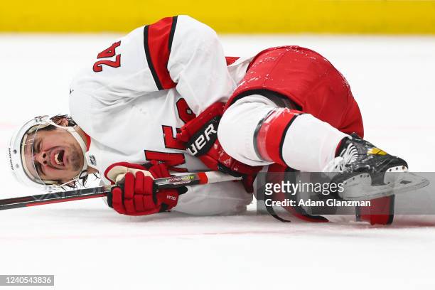 Seth Jarvis of the Carolina Hurricanes reacts after being hit by a loose puck in the second period against the Boston Bruins in Game Four of the...