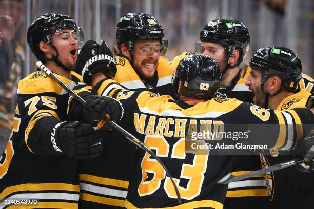 David Pastrnak of the Boston Bruins reacts with teammates after scoring in the third period against the Carolina Hurricanes in Game Four of the First...