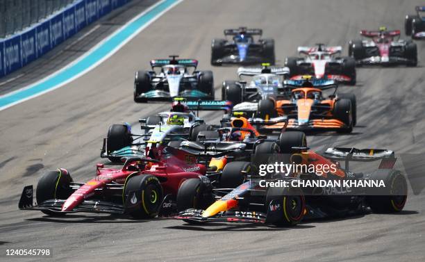 Ferrari's Spanish driver Carlos Sainz and Red Bull Racing's Dutch driver Max Verstappen race at the start of the Miami Formula One Grand Prix at the...
