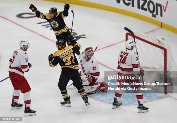 Boston Bruins' David Pastrnak and Patrice Bergeron celebrate goal by Brad Marchand during the third period of Game 4 of Eastern First Round playoffs...