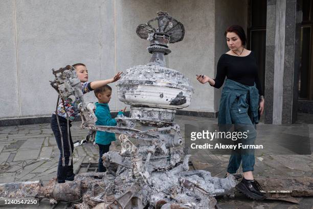 Family inspects the remnants of Russian military aircraft in the exhibition Ukraine: Crucifixion at the National Museum of the History of Ukraine in...