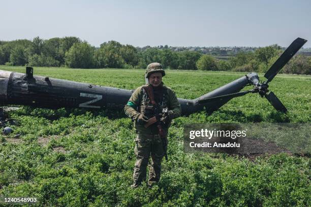 Ukrainian soldiers in a downed Russian helicopter in the outskirts of Kharkiv, Ukraine, 8 May 2022