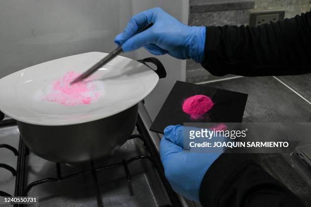 Man prepares a powder known as Tussi or pink cocaine in Medellin, Colombia, on April 2, 2022. - Three decades after Pablo Escobar's shot body was...