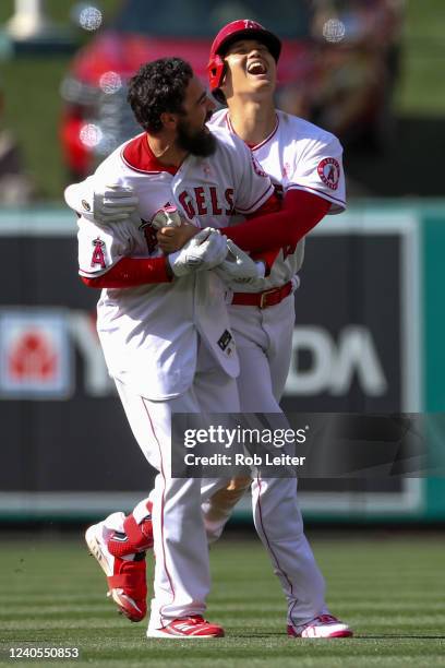 Anthony Rendon of the Los Angeles Angels celebrates with Shohei Ohtani after hitting a walk off single to defeat the Washington Nationals at Angel...