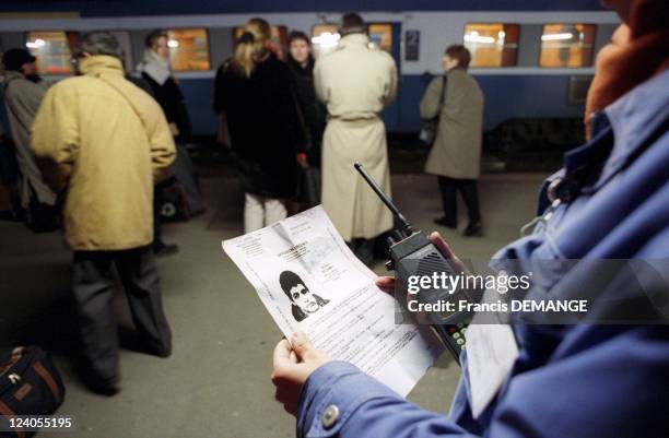 Murders in French trains: An SNCF agent Holding Portrait of suspect Sid Ahmed Rezala In Dijon, France On December 16, 1999.