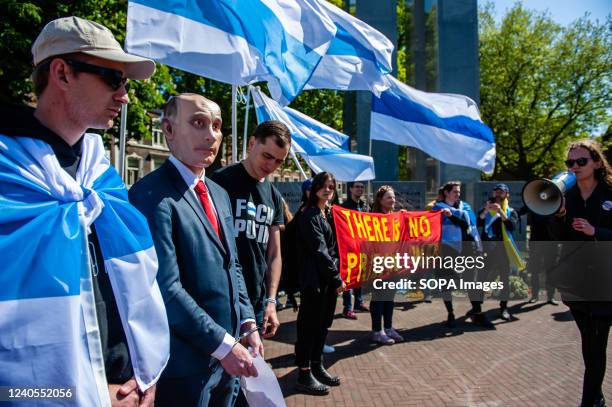 Woman is seen giving a speech against Putin regime in front of a man dressed as him during the demonstration, On May 8, members of the Russian...