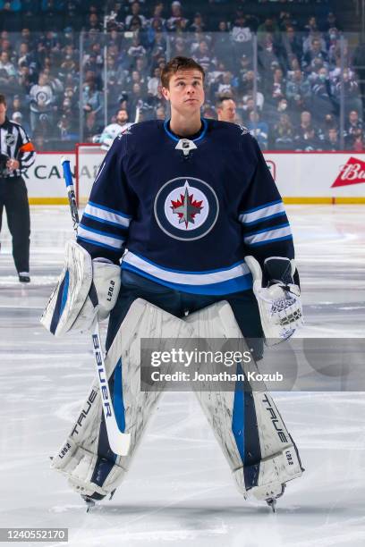 Goaltender Eric Comrie of the Winnipeg Jets looks on prior to NHL action against the Seattle Kraken at Canada Life Centre on May 01, 2022 in...