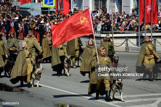 Participants wearing historical uniforms take part in a military parade, which marks the 77th anniversary of the Soviet victory over Nazi Germany in...