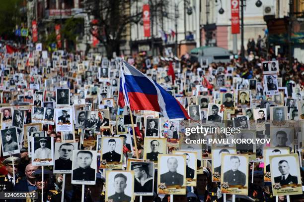 People carry portraits of their relatives - WWII soldiers - as they take part in the Immortal Regiment march in the far eastern city of Vladivostok...