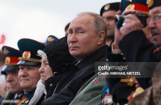 Russian President Vladimir Putin watches the Victory Day military parade at Red Square in central Moscow on May 9, 2022. - Russia celebrates the 77th...