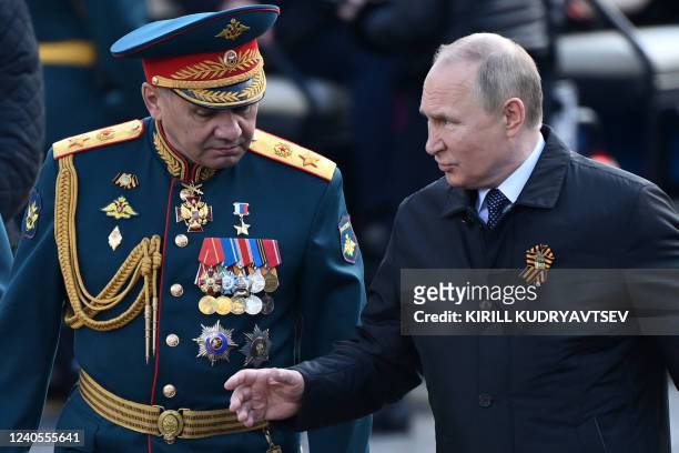 Russian President Vladimir Putin and Defence Minister Sergei Shoigu leave Red Square after the Victory Day military parade in central Moscow on May...