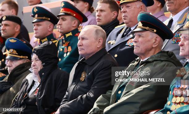 Russian President Vladimir Putin watches the Victory Day military parade at Red Square in central Moscow on May 9, 2022. - Russia celebrates the 77th...