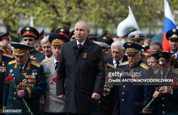 Russian President Vladimir Putin attends a flower-laying ceremony at the Tomb of the Unknown Soldier after the Victory Day military parade in central...