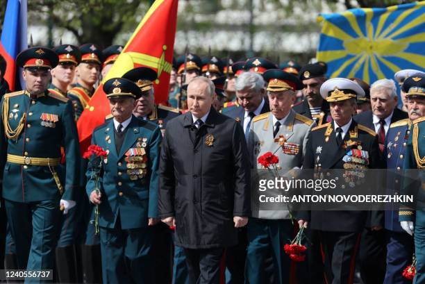 Russian President Vladimir Putin attends a flower-laying ceremony at the Tomb of the Unknown Soldier after the Victory Day military parade in central...