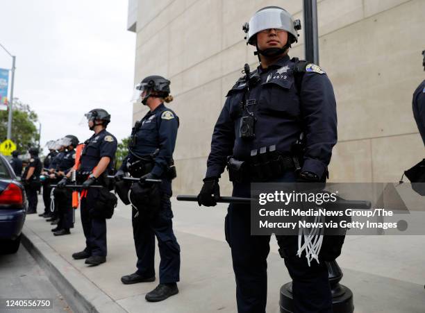 San Jose Police officers stand guard outside of San Jose City Hall during a protest for George Floyd in downtown San Jose, Calif., on Sunday, May 31,...
