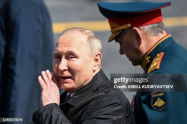 Russian President Vladimir Putin and Defence Minister Sergei Shoigu leave Red Square after the Victory Day military parade in central Moscow on May...