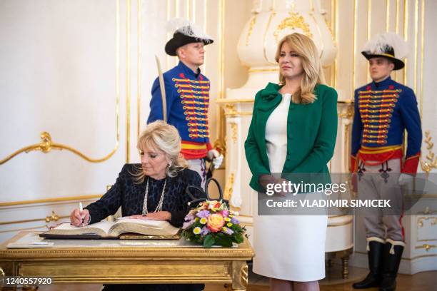 First Lady Jill Biden signs the Golden Book as Slovak President Zuzana Caputova looks on inside the Presidential Palace in Bratislava on May 09,...