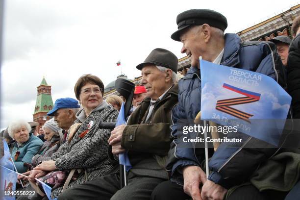 Spectators wearing ribbons with letter 'Z', a symbol of support to military invasion on Ukraine, watch the Victory Day Parade at Red Square, May...