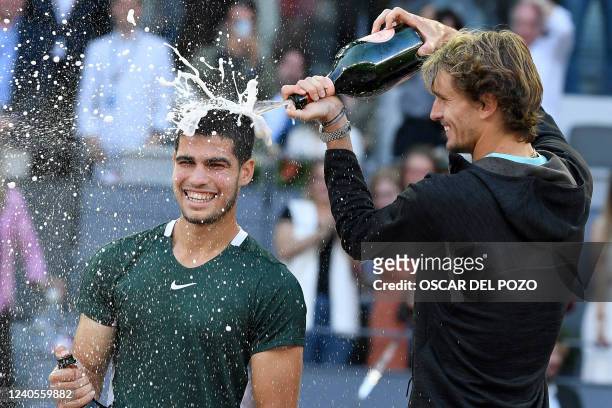 Spain's Carlos Alcaraz celebrates with Germany's Alexander Zverev after winning the 2022 ATP Tour Madrid Open tennis tournament men's singles final...