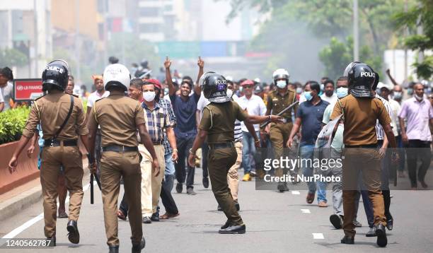 Demonstrators and government supporters clash in Colombo on May 9, 2022. Police imposed an indefinite curfew in Sri Lanka's capital on May 9 after...