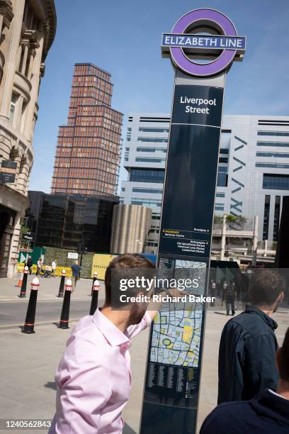 Post outside one of Liverpool Street Station's Elizabeth Line's entrance is seen with a man seemingly pointing to a map of the City of London, the...