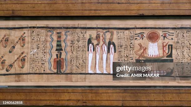 This picture taken on May 3, 2022 shows a view of hieroglyphs along a section of one of the scrolls of the Egyptian Book of the Dead on display along...