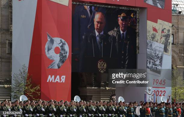 Russian President Vladimir Putin seen on the screen speacking during the Victory Day Parade at Red Square on May 9, 2022 in Moscow, Russia. The Red...