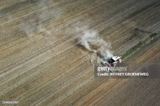 An aerial view shows dust from a tractor working on a dry field near Strijen on May 9, 2022. - Netherlands OUT / Netherlands OUT / luchtfoto,Jeffrey...