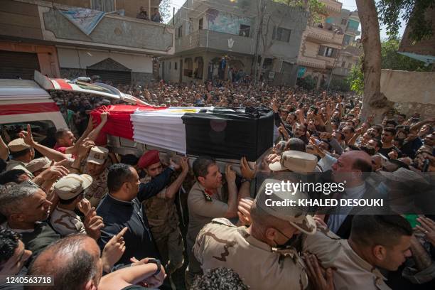 Mourners and soldiers carry the casket of Egyptian First Lieutenant Soleman Ali Soleman, one of 11 soldiers killed in an attack claimed by the...