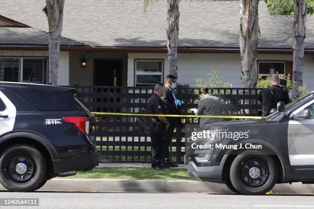 Los Angeles, CA Law enforcement personnel investigate the scene where three children were found dead at a residence after police responded to assault...