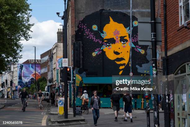 Re-painted version of the iconic 'Yellow Face Lady' mural by Colombian street artist Stinkfish which was originally painted in 2012 on the corner of...