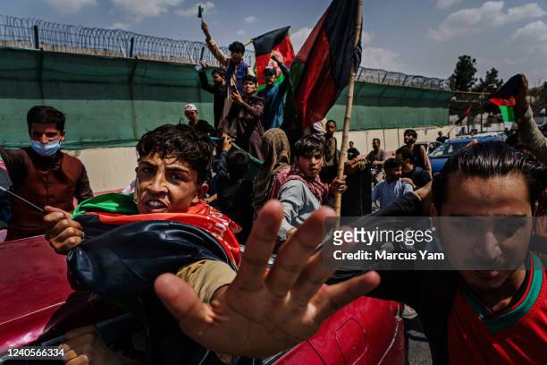 Anti-Taliban protesters mark Afghanistan's independence day by attempting to hoist the red, green and black national banner. They were often beaten...
