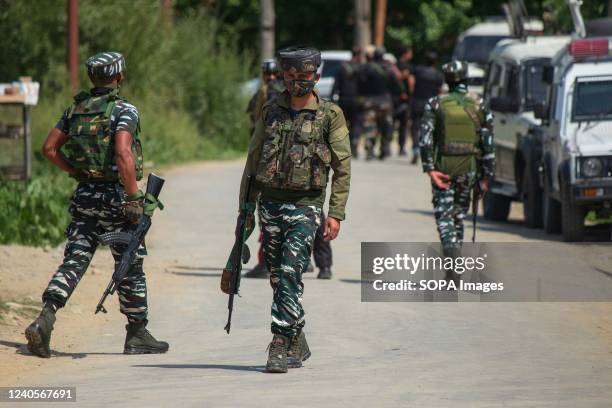 Indian paramilitary troopers stand alert at the site of an encounter which according to local media broke out between militants and Indian government...