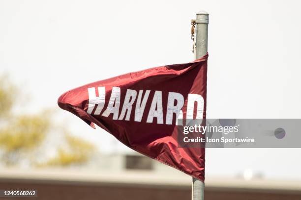 Harvard Crimson flag waves in the wind during the Ivy League Tournament championship college lacrosse game between the Pennsylvania Quakers and the...