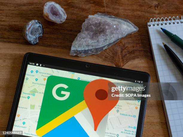 In this photo illustration Google Maps logo seen displayed on a tablet.