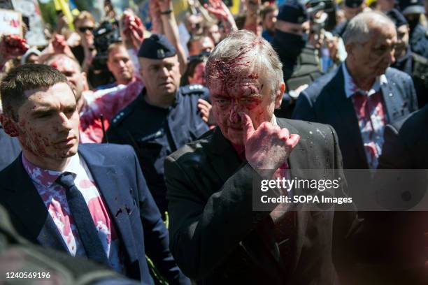 Russia's ambassador to Poland, Sergey Andreev covered in red paint leaves the Soviet soldiers cemetery. Hundreds of Ukrainians and Polish activists...