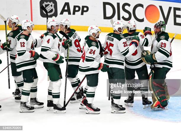 Minnesota players congratulate Minnesota Wild goalie Marc-Andre Fleury after winning game 3 of the first round of the NHL Stanley Cup Playoffs...