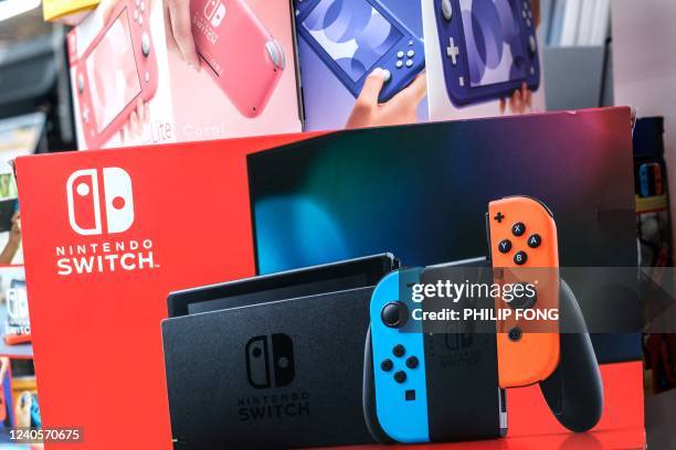 This picture taken on May 9 shows a box of Nintendo Switch video game console is displayed at the self of video games and accessories at the gaming...