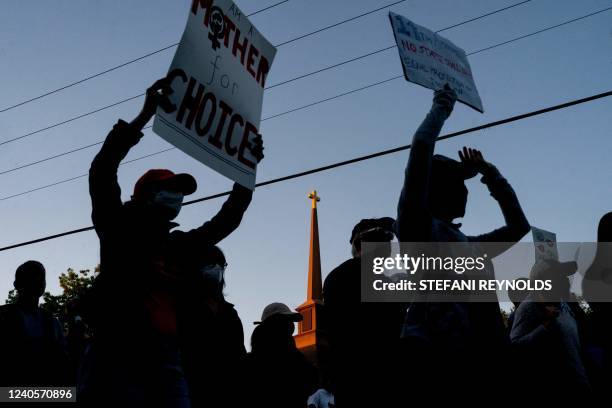 Cross is seen on top of a church steeple as pro-choice demonstrators march to the house of US Supreme Court Justice Samuel Alito in Alexandria,...